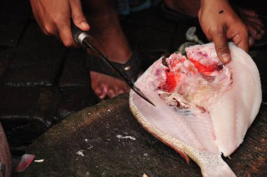 Pala kullanarak balık gutting. Bir yemek hazırlama.