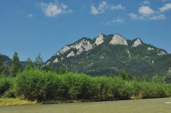 Bald mountain tops, Three Crowns in the Pieniny National Park in Poland. View from the Dunajec riverbed during rafting with rafts.