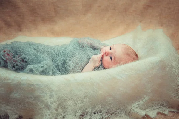 Newborn baby lies in a crib. — Stock Photo, Image