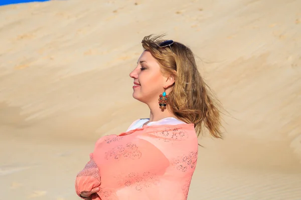 Красивая блондинка с розовой тканью в пустыне . — стоковое фото