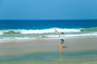 Adam sahilde resimler alıyor.