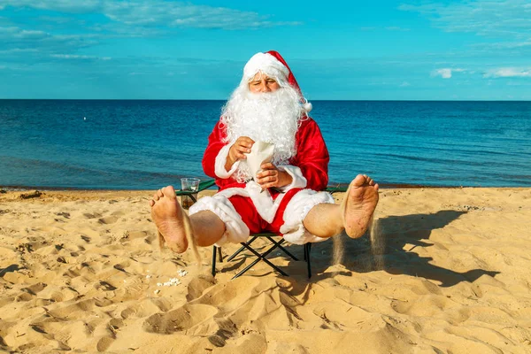 Santa Claus is resting on the beach. Stock Picture