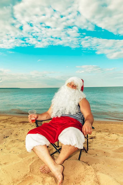 Santa Claus is sitting on the beach. Royalty Free Stock Images