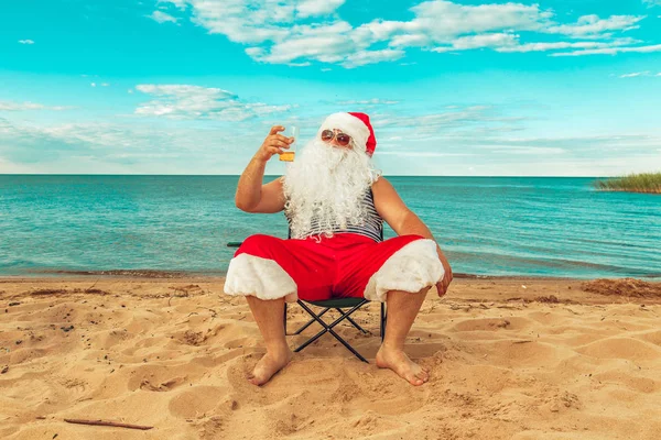 Santa Claus is sitting on the beach. Stock Picture