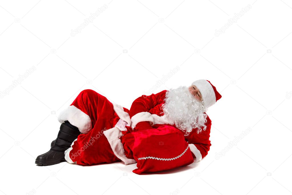 Santa Claus is lying with a bag of gifts. 