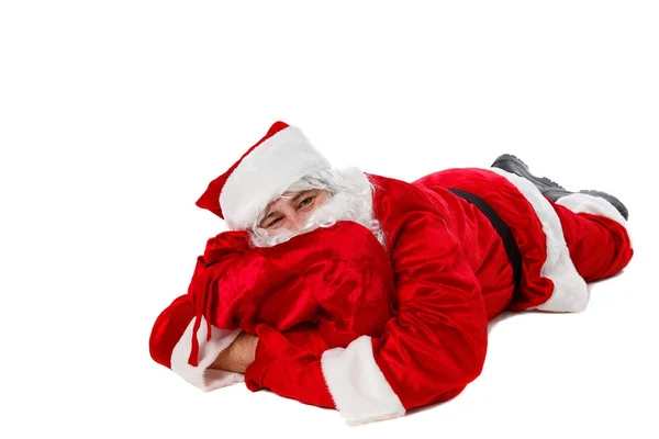 Święty Mikołaj leży z torbą prezentów.. — Zdjęcie stockowe
