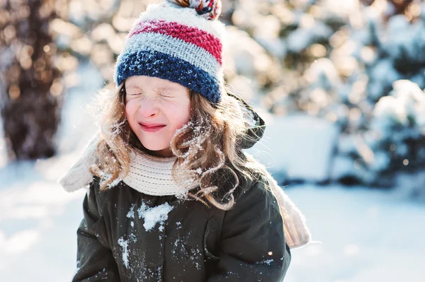 Joyeuse enfant fille jouant avec la neige en hiver promenade enneigée dans le jardin, activités de plein air saisonnières en vacances — Photo