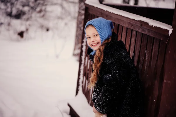 Lyckligt drömmande barn flicka vandrar i snörik vinter skog — Stockfoto