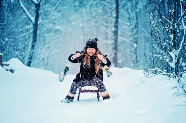 Šťastné dítě zasněný dívka procházky v zasněžené zimní les — Stock fotografie