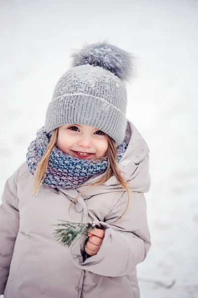 Cute happy baby girl walking in snowy winter forest, spending Christmas vacations outdoor — Stock Photo, Image