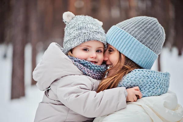 Retrato de inverno de bebê bonito menina em tamanho grande cinza de malha cachecol andando na floresta nevada — Fotografia de Stock