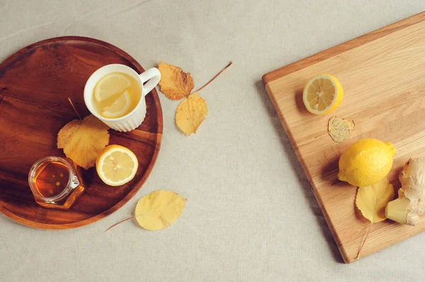 Cozinhar gengibre, limão e mel chá quente em casa. ingredientes e xícara no fundo de madeira . — Fotografia de Stock