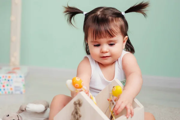 Close up indoor portrait of cute happy baby girl playing with easter decorations — Stock Photo, Image