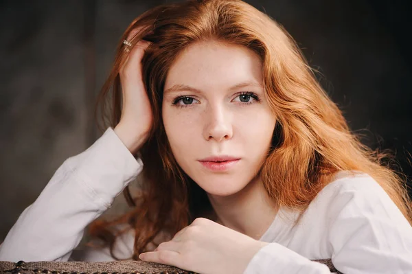 Close up indoor portrait of adorable thoughtful young redhead woman with freckles and long hair — Stock Photo, Image