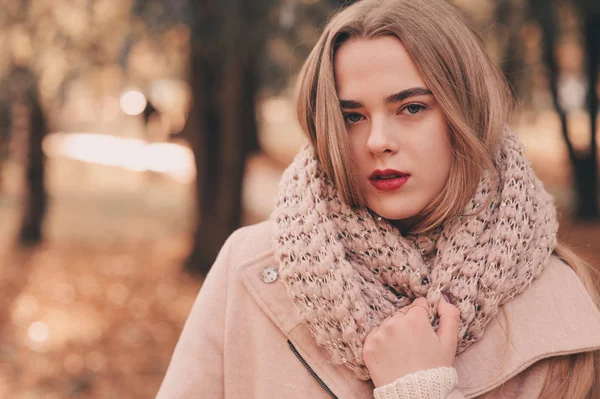 Retrato de una joven hermosa mujer caminando en un traje cálido y elegante en un día soleado de otoño en el parque, vistiendo un abrigo rosa y una faja de punto. Estilo de vida casual en la ciudad —  Fotos de Stock