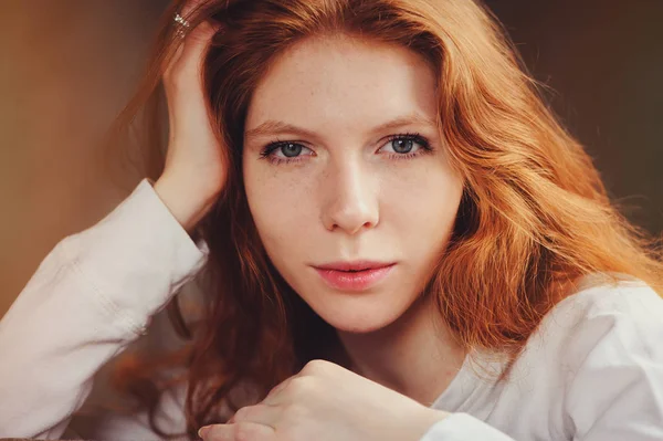 Close up indoor portrait of adorable thoughtful young redhead woman with freckles and long hair — Stock Photo, Image