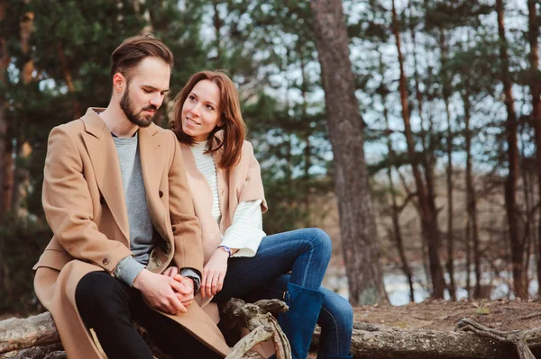 Young happy loving couple walking outdoor in autumn or early spring — Stock Photo, Image