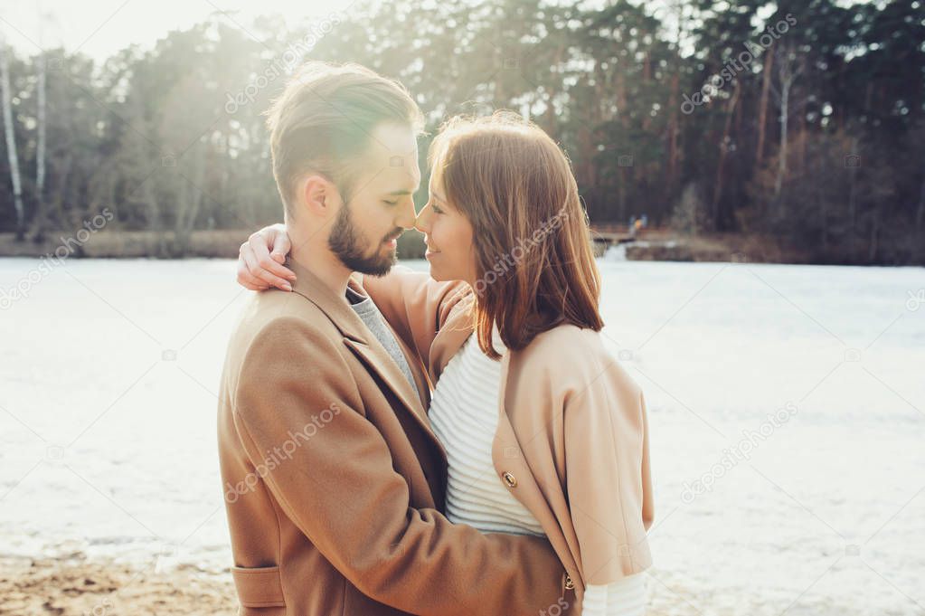 young happy loving couple walking outdoor in autumn or early spring