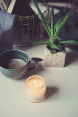 kış sabahı evde rahat. Sıcak kakao veya kahve mum ve etli beyaz masada