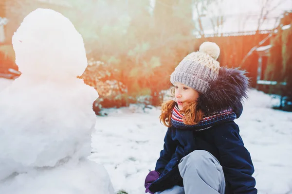 Szczęśliwy Dziewczyna Człowiek Śniegu Boże Narodzenie Wakacje Podwórku Zimowe Atrakcje — Zdjęcie stockowe