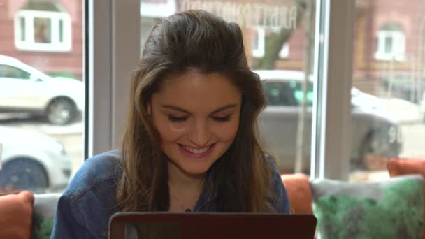 Happy young woman Surfing Internet On Tablet Touchscreen In Cafe — Stock Video