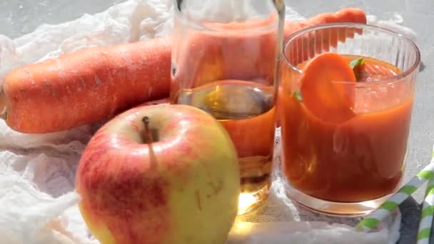 Organic vegetarian drink and of carrots and apple with oil. Healthy eating concept. — 图库视频影像