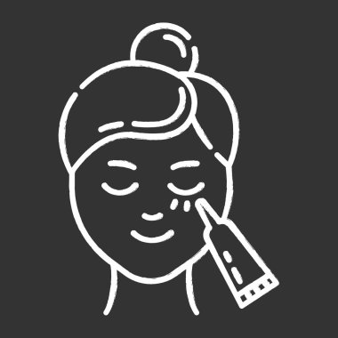 Göz altı kremi tebeşir ikonu kullanıyor. Deri bakımı prosedürü. Yüz bakımı.