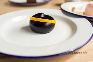 Çeşitli tatlılar beyaz tabaklar ve marshmallow ile masada. Kiraz, çikolata