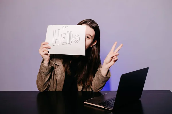 The girl teaching English and shows phrases using signs at. Innovative pedagogy to teaching in online school.A new english course is available online.