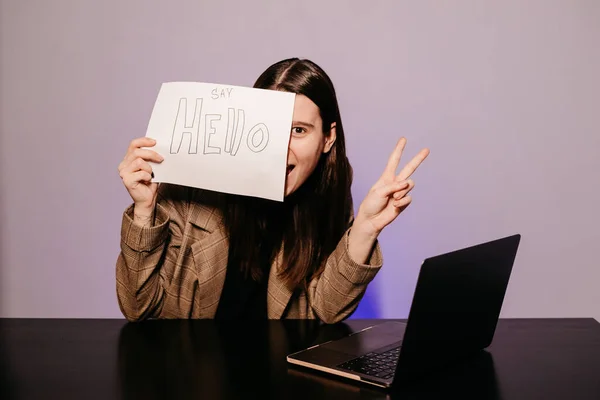 The girl teaching English and shows phrases using signs at. Innovative pedagogy to teaching in online school.A new english course is available online.