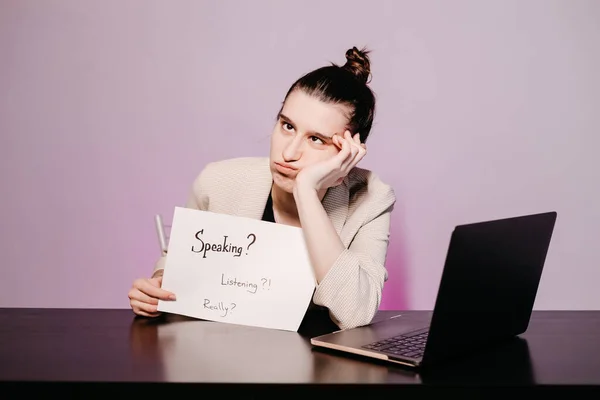 The girl teaching English and shows phrases using signs at. Innovative pedagogy to teaching in online school.A new english course is available online.