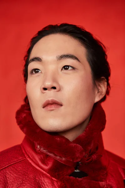 Asian man in red clothes on a red background