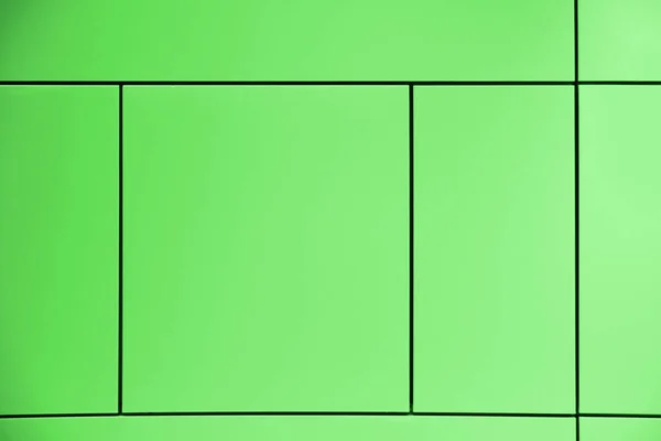 Verdor. Fondo verde atravesado por líneas que forman cuadrados y rectángulos en una pared arquitectónica abstracta. Espacio de copia vacío — Foto de Stock