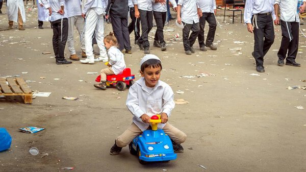 Uman, Ukraine - 21 September 2017: Rosh Hashanah, Jewish New Year 5778. It is celebrated near the grave of Rabbi Nachman in Uman. While adults pray, children play. A lot of trash.