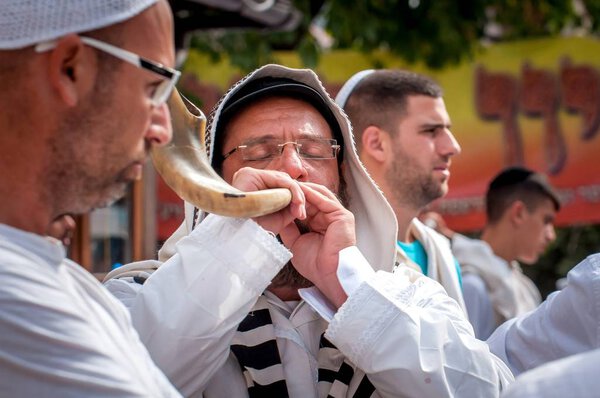 Jewish hasid blows Shofar. Uman, Ukraine - 21 September 2017: Rosh Hashanah, Jewish New Year.