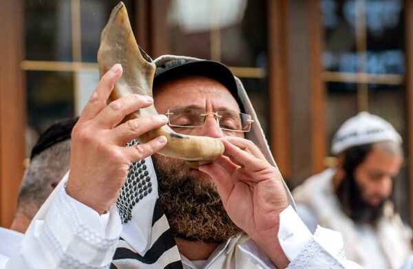 Jewish hasid blows Shofar. Uman, Ukraine - 21 September 2017: Rosh Hashanah, Jewish New Year.