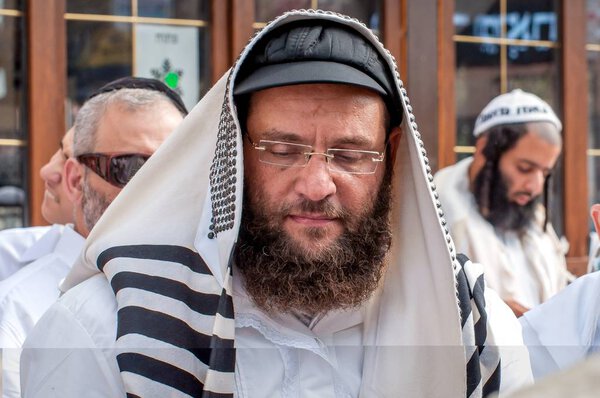 Hasids pilgrims in traditional clothes. Tallith - jewish prayer shawl. Uman, Ukraine - September 21, 2017: Rosh-ha-Shana festival, Jewish New Year.