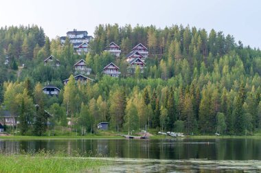 Finland - August 1, 2018. Ukkohalla Ski Resort is located in Central Finland, the Kainuu region. The most environmentally friendly air. A lake in the middle of a forest. Cozy picturesque cottages.