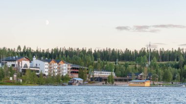 Finland - August 19, 2018. Ukkohalla Ski Resort is located in Central Finland, the Kainuu region. The most environmentally friendly air. A lake in the middle of a forest. Cozy picturesque cottages.
