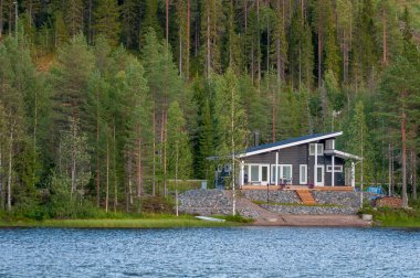 Finland - August 19, 2018. Ukkohalla Ski Resort is located in Central Finland, the Kainuu region. The most environmentally friendly air. A lake in the middle of a forest. Cozy picturesque cottages.