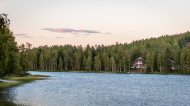 Finland - August 19, 2018. Ukkohalla Ski Resort is located in Central Finland, the Kainuu region. The most environmentally friendly air. A lake in the middle of a forest. Cozy picturesque cottages.