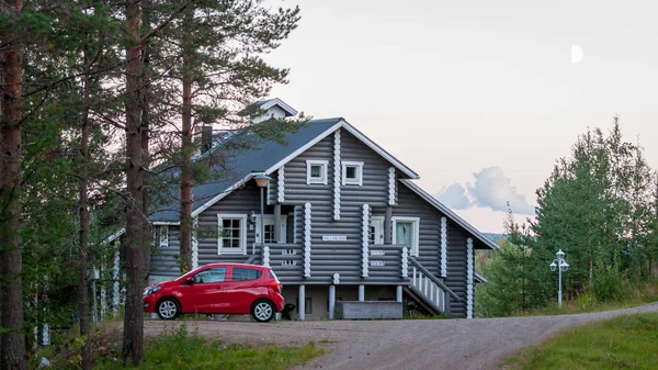 Finland - August 19, 2018. Ukkohalla Ski Resort is located in Central Finland. A cozy picturesque cottage in the middle of an ecologically clean coniferous forest. A red car is parked near the house.