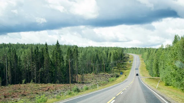 Φινλανδία. Άποψη ενός γραφικού δρόμου που διέρχεται από ένα δάσος. Όμορφο σκανδιναβικό τοπίο. — Φωτογραφία Αρχείου
