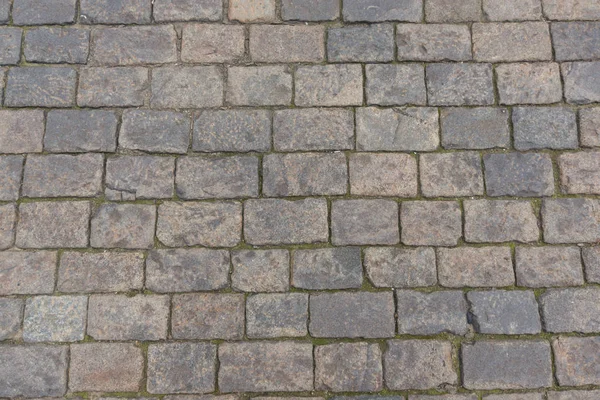Ancient paving road in the center of the city close up — Stock Photo, Image