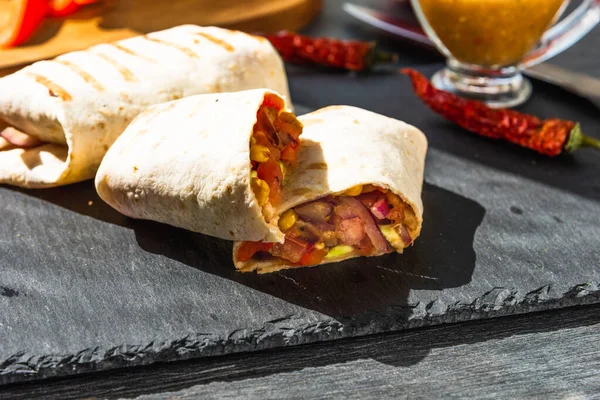 Traditional Mexican burrito on a serving board closeup