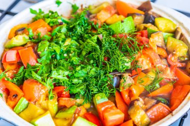 Vejetaryen mutfağı - kızartma tavasında kızartılmış sebzeler ve doğranmış maydanoz ve dereotu.