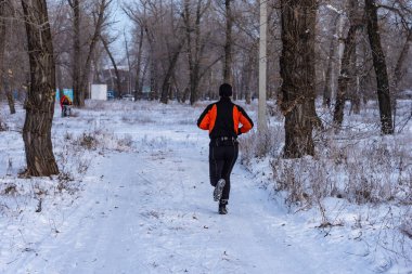 Engels, Rusya - 1 Aralık 2018: Bir atlet kış parkında koşarken antrenman yapıyor