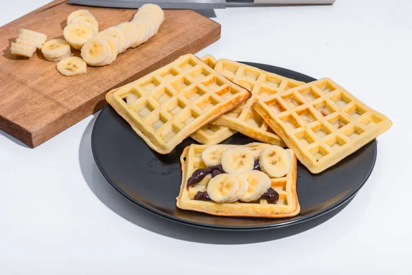 Belgian Homemade Waffles Chocolate Sauce Bananas Black Plate — Stock Photo, Image