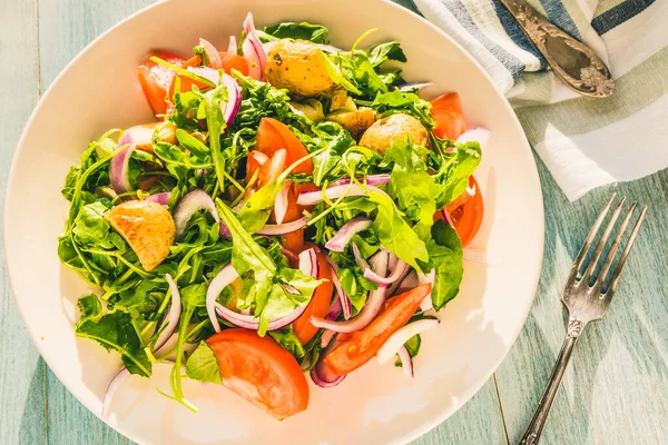 German food - a traditional vegetarian salad with potatoes, tomatoes, onions and arugula