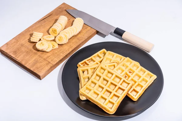 Belgian Homemade Waffles Black Plate Sliced Banana Slices Cutting Board — Stock Photo, Image
